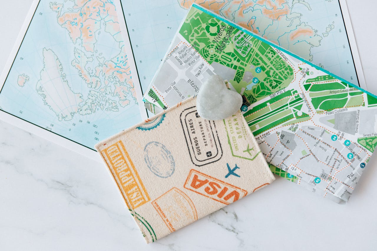 Mastering the First Impression: Your intriguing post title goes here An overhead view of a passport holder on top of maps, symbolizing travel and exploration.